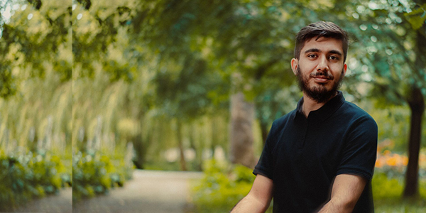 a york sanctuary fund scholar recipient sat down with trees in the background